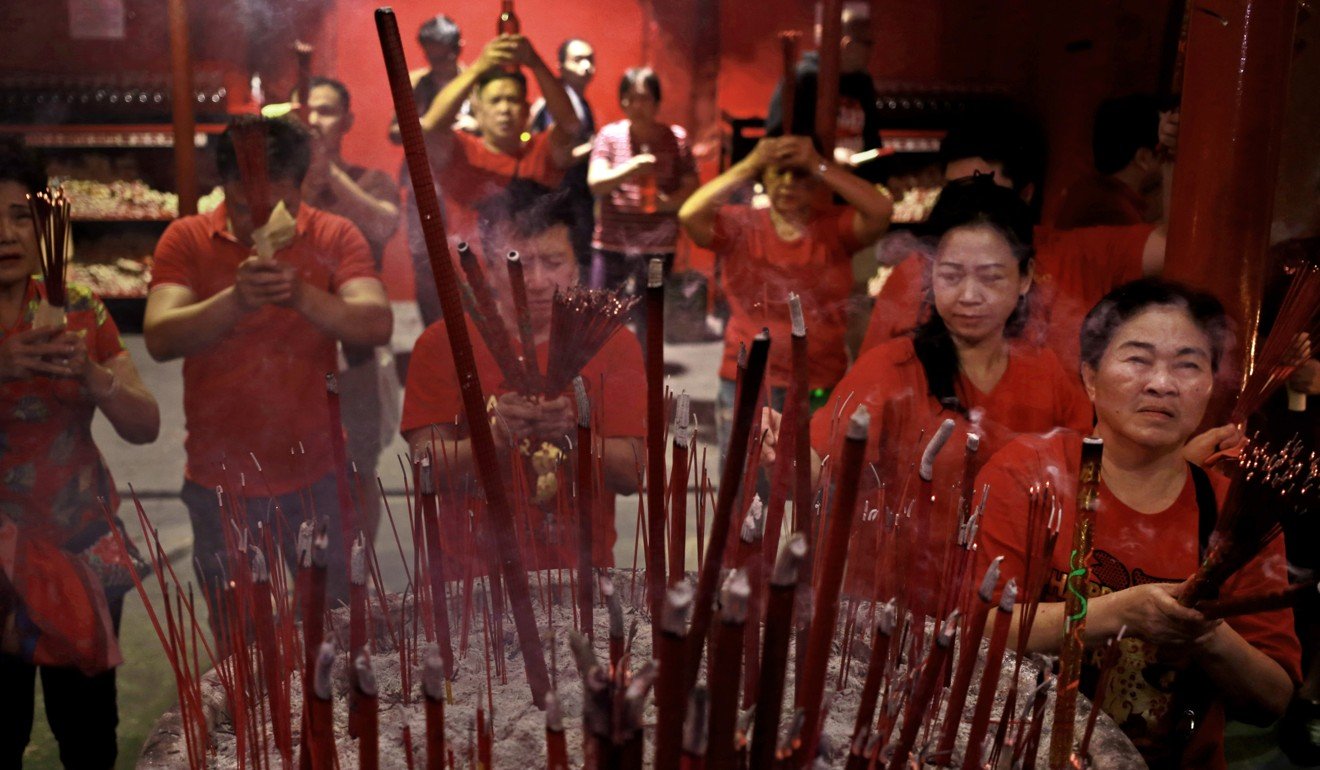 Ethnic Chinese Indonesians pray during the Lunar New Year celebration at a temple in Chinatown in Jakarta, Indonesia. The position and treatment of ethnic Chinese people in Indonesia has periodically been a source of tension between the two nations. Photo: AP