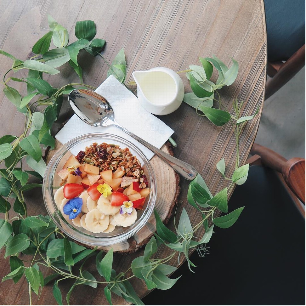 A bowl of fruit with granola served at Anther & Stigma Floral Cafe