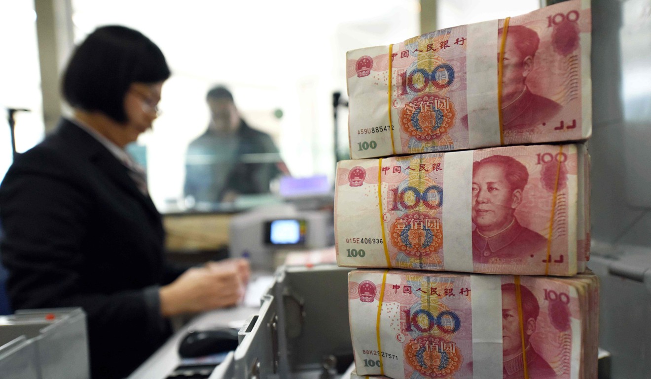 A bank employee counts 100-yuan bills at a bank in Lianyungang, eastern China's Jiangsu province. In the event of a trade war with the United States, China could resort to devaluing its currency or dumping its massive holdings of US debt. Photo: AFP