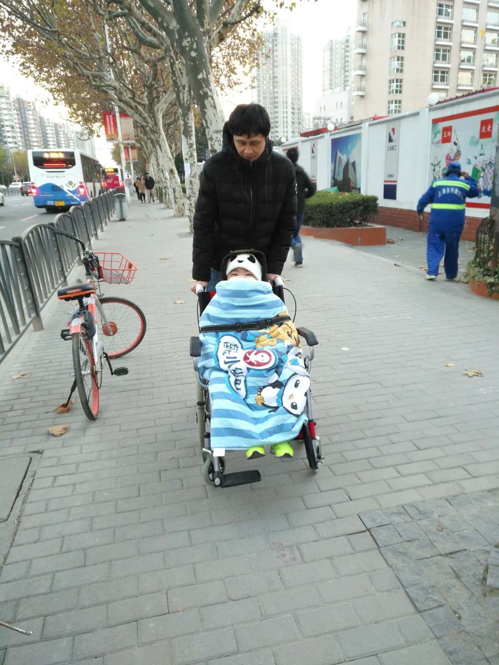 Gu Xingping takes his son to hospital in Shanghai. Photo: Fan Xiujuan
