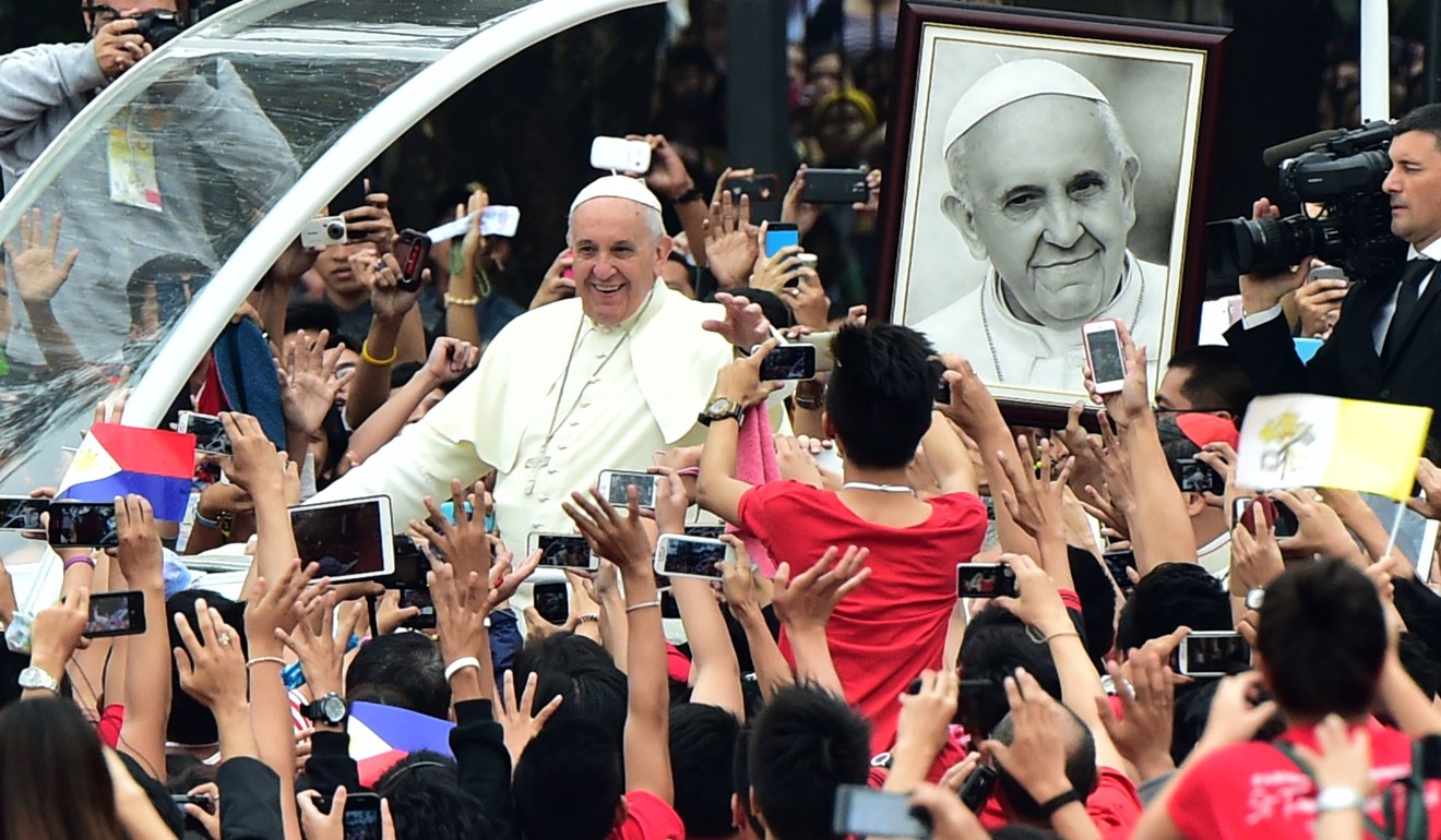 Pope Francis waves as he arrives for a meeting with youths at the University of Santo Tomas in Manila on January 18, 2015. The Philippines is the Catholic Church’s Asian heartland, where divorce and abortion remain illegal. Photo: Agence France-Presse
