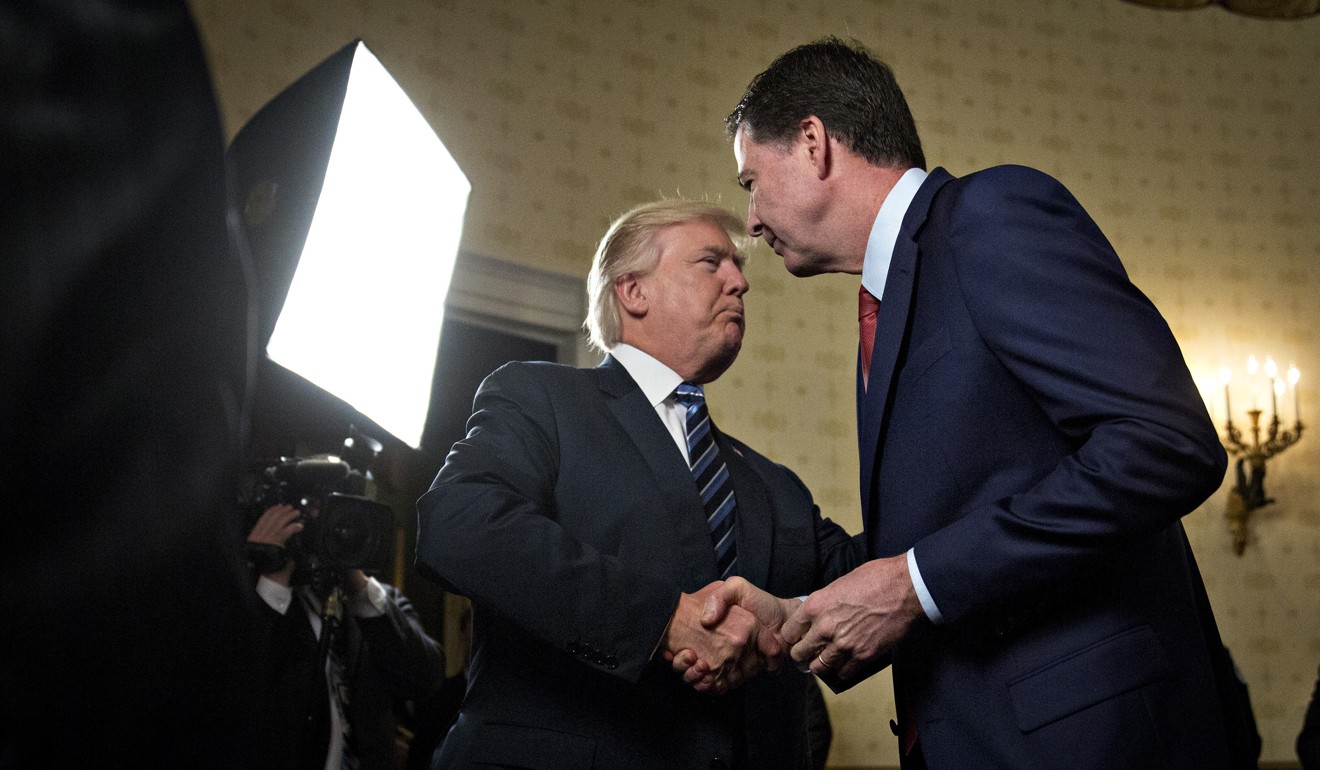 US President Donald Trump shakes hands with James Comey, then director of the Federal Bureau of Investigation in January 2017. File photo: TNS