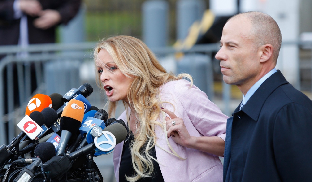 Adult film actress Stephanie Clifford, also known as Stormy Daniels, speaks outside the federal courthouse in New York on Monday with her lawyer, Michael Avenatti. Photo: Agence France-Presse 