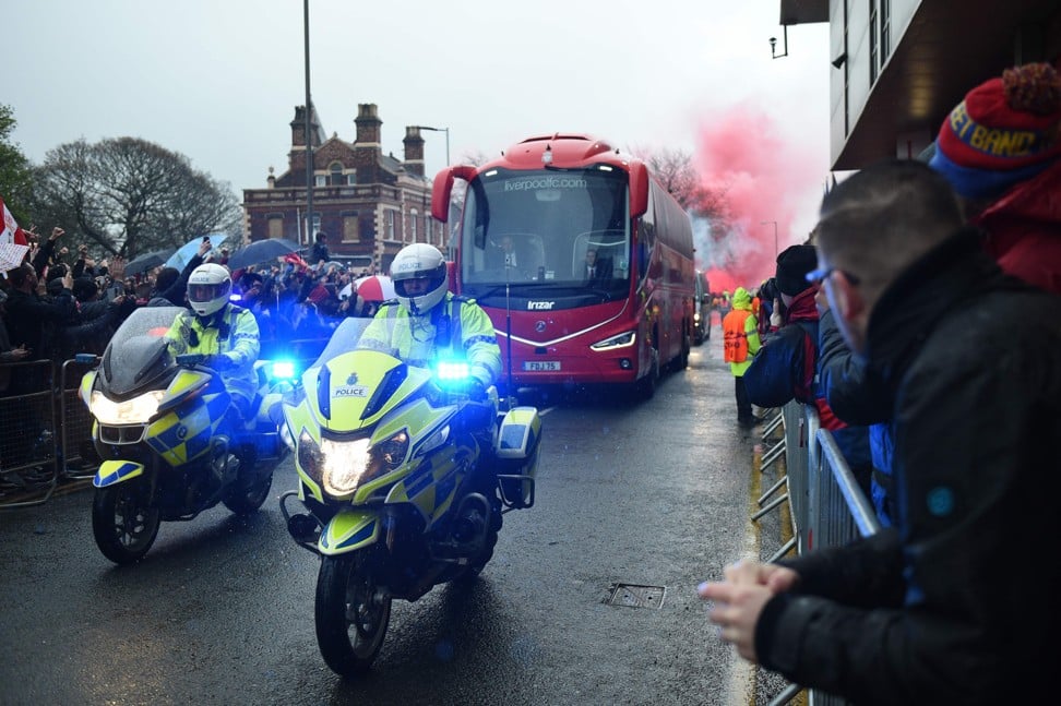 Police escort a coach carrying the Liverpool team to Anfield. Photo: AFP