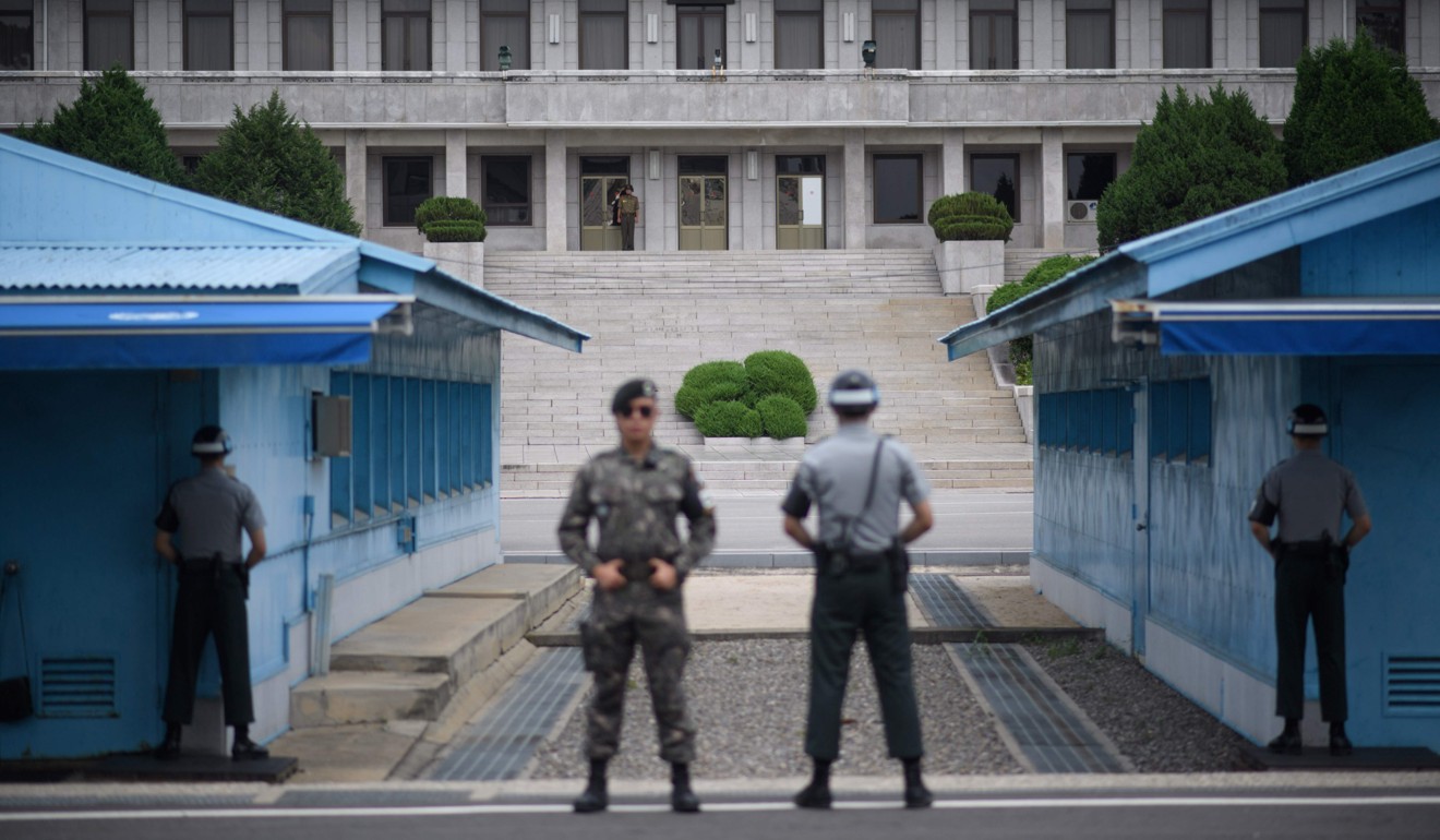 South Korean soldiers on guard in front of the North Korean side of the truce village at Panmunjom, within the demilitarized zone separating the two countries. Photo: Agence France-Presse