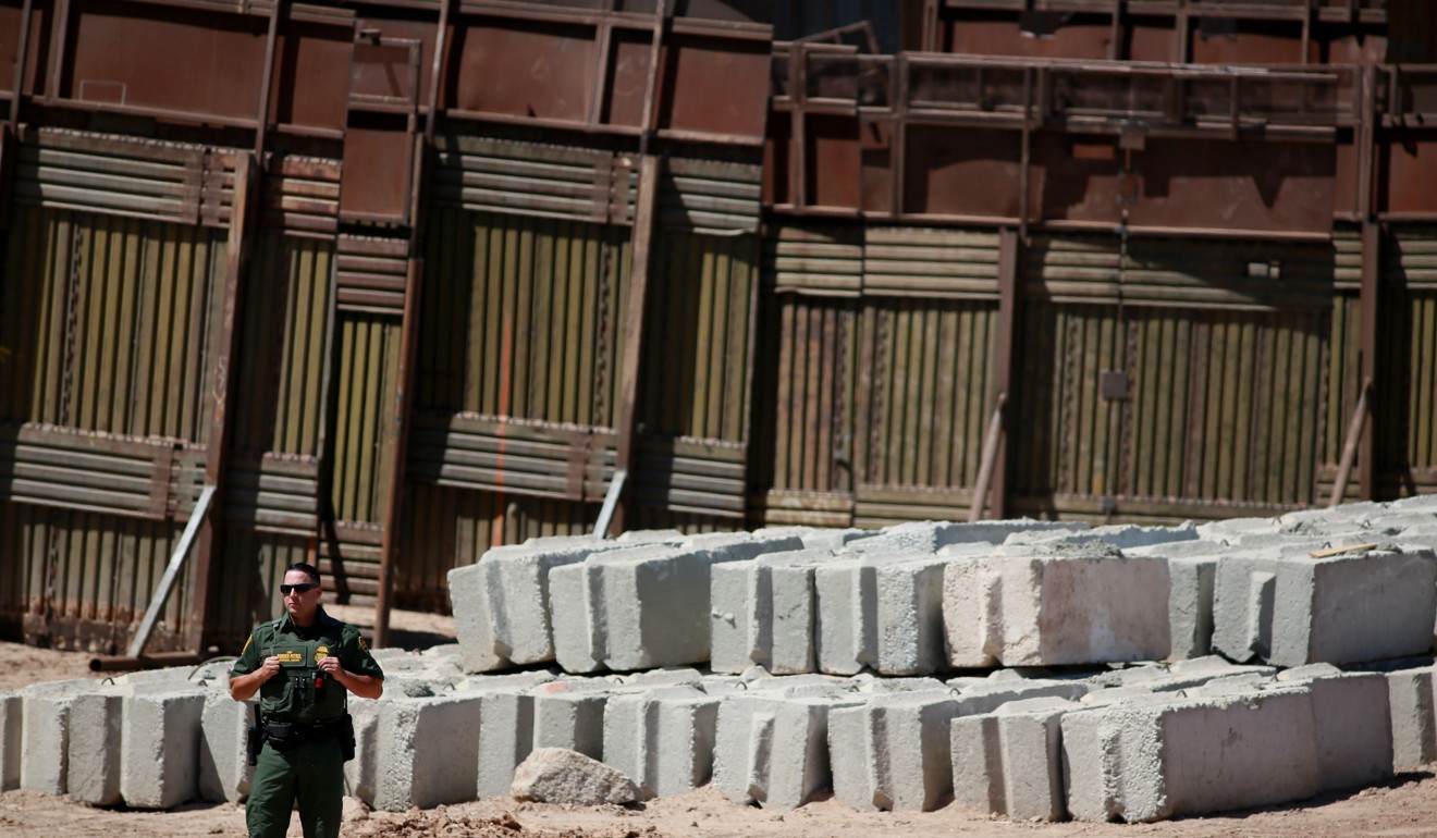 A US Border Patrol agent stands guard in front of border wall construction in Calexico, California. Photo: Bloomberg