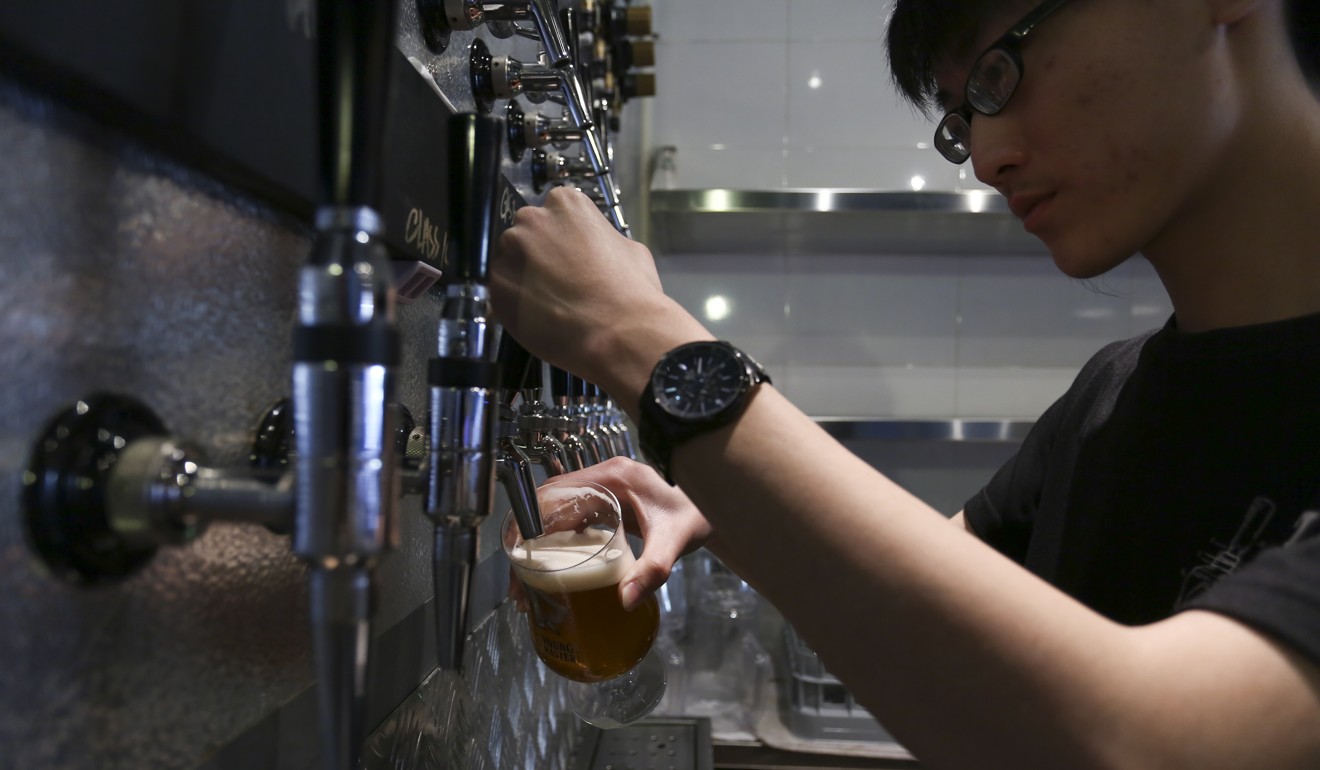 A barman pulls a beer at Tap – The Ale Project in Mong Kok. Photo: Jonathan Wong