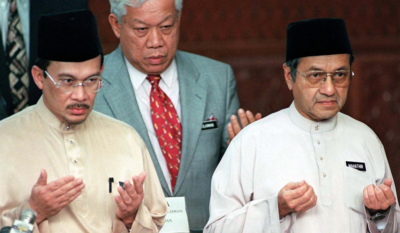 Then deputy prime minister Anwar Ibrahim (left) and prime minister Mahathir Mohamed (right) offer prayers at Malaysia’s budget report presentation in Kuala Lumpur in October 1998. Anwar was widely known to be Mahathir’s successor until he criticised his mentor and found himself charged with sodomy and abuse of power, for which he was jailed. Photo: Reuters. 