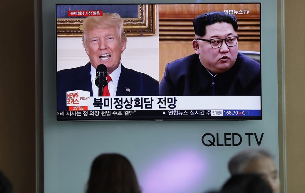 People watch a television screen showing file footage of US President Donald Trump and North Korean leader Kim Jong-un, right, during a news programme at the Seoul railway station in Seoul, South Korea on May 11. Photo: AP