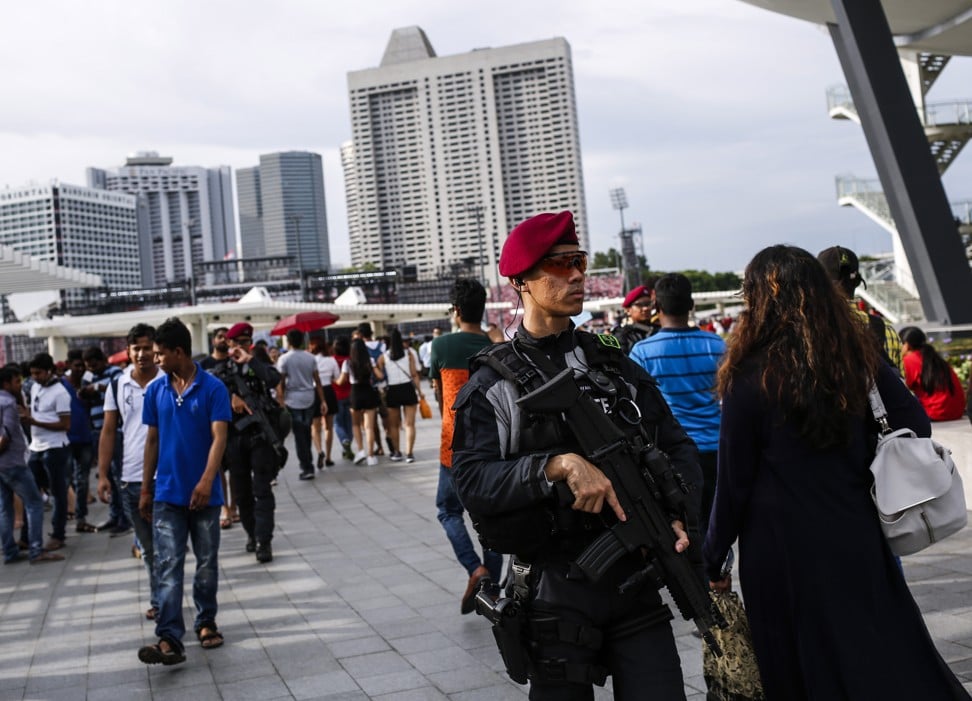A security officer from the Singapore police force's special operations command unit patrols the walkway along Marina Bay during the National Day Parade in Singapore in 2017. Photo: EPA-EFE