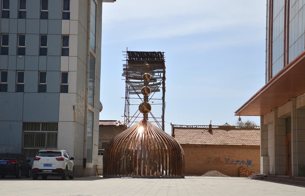 A gold dome is seen on the ground after it was removed from a hotel in Tongxin county. Photo: Nectar Gan