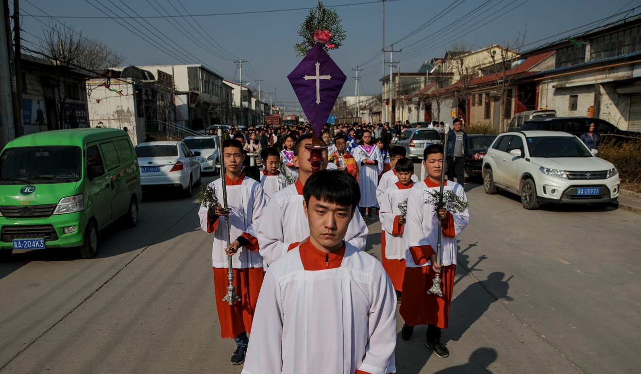 A Palm Sunday procession makes its way towards a government-sanctioned Catholic church in Hebei province in March. Photo: Reuters