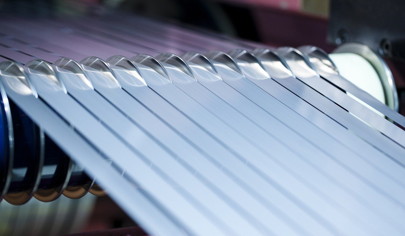 Stainless steel strips pass though a cutting machine in Hisar, India, on May 15. Photo: Bloomberg