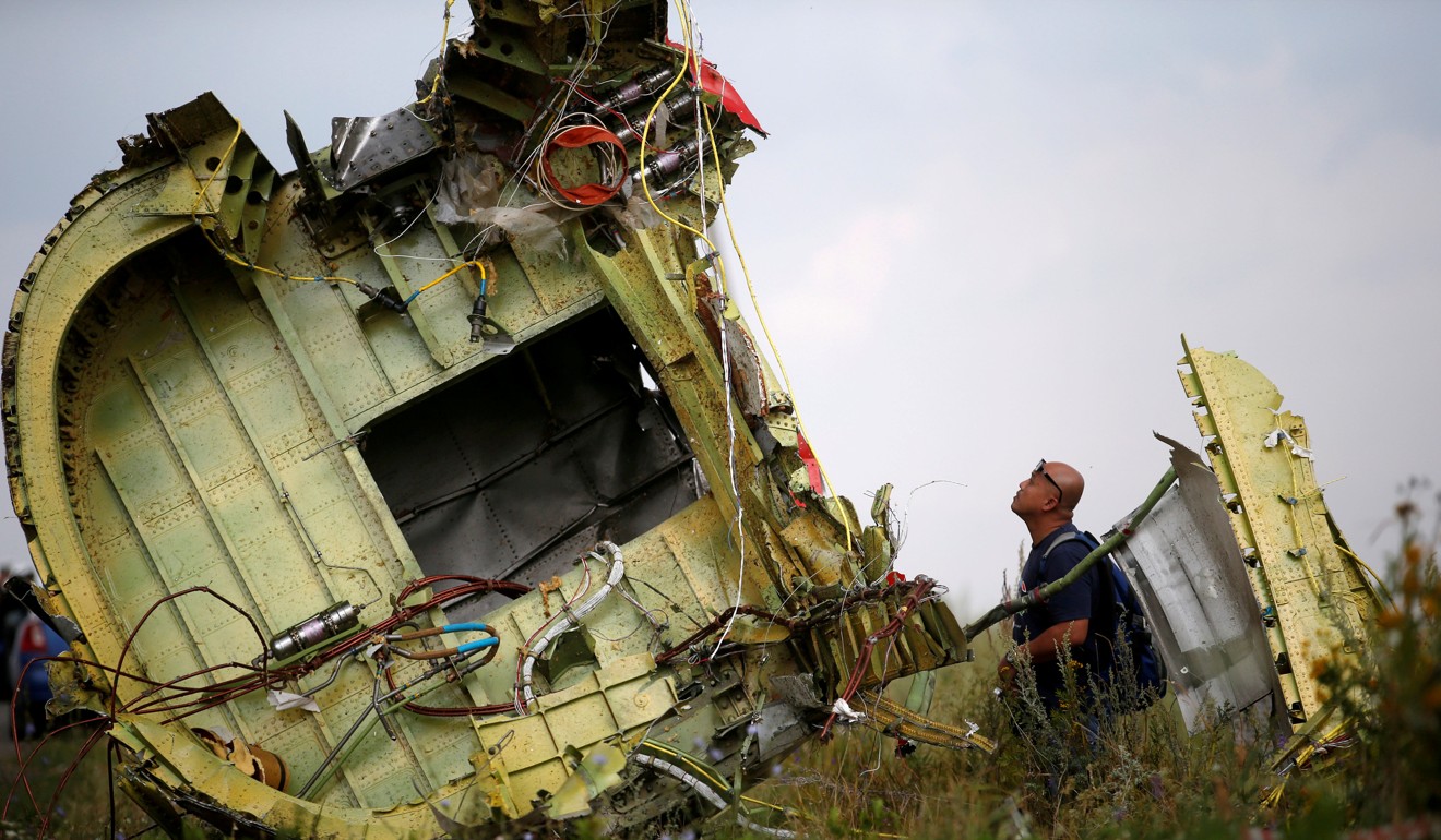 A Malaysian air crash investigator inspects the crash site of Malaysia Airlines Flight MH17. Photo: Reuters