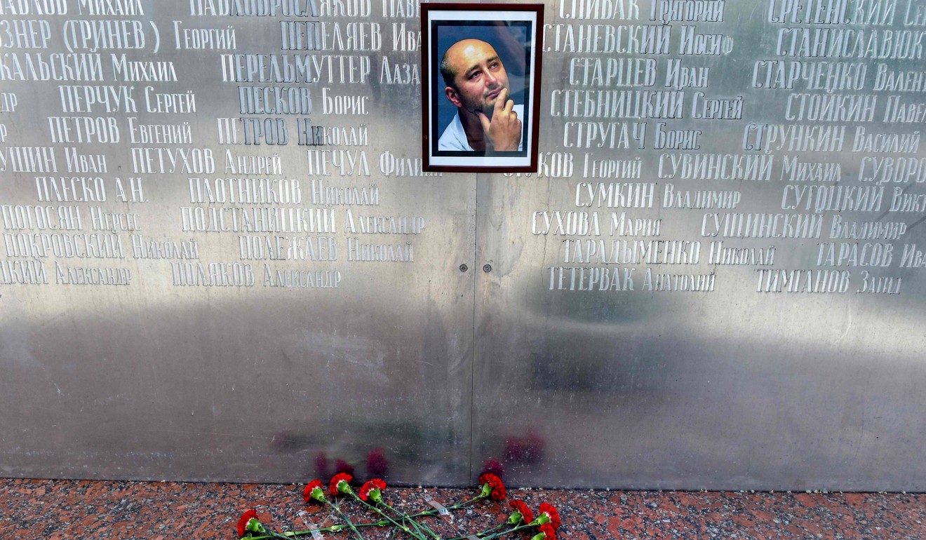 Flowers lay under a picture of Arkady Babchenko in Moscow, Russia on Wednesday. Babchenko turned up alive at a news conference in Ukraine on Wednesday after he was reported to have been shot to death. Photo: AFP