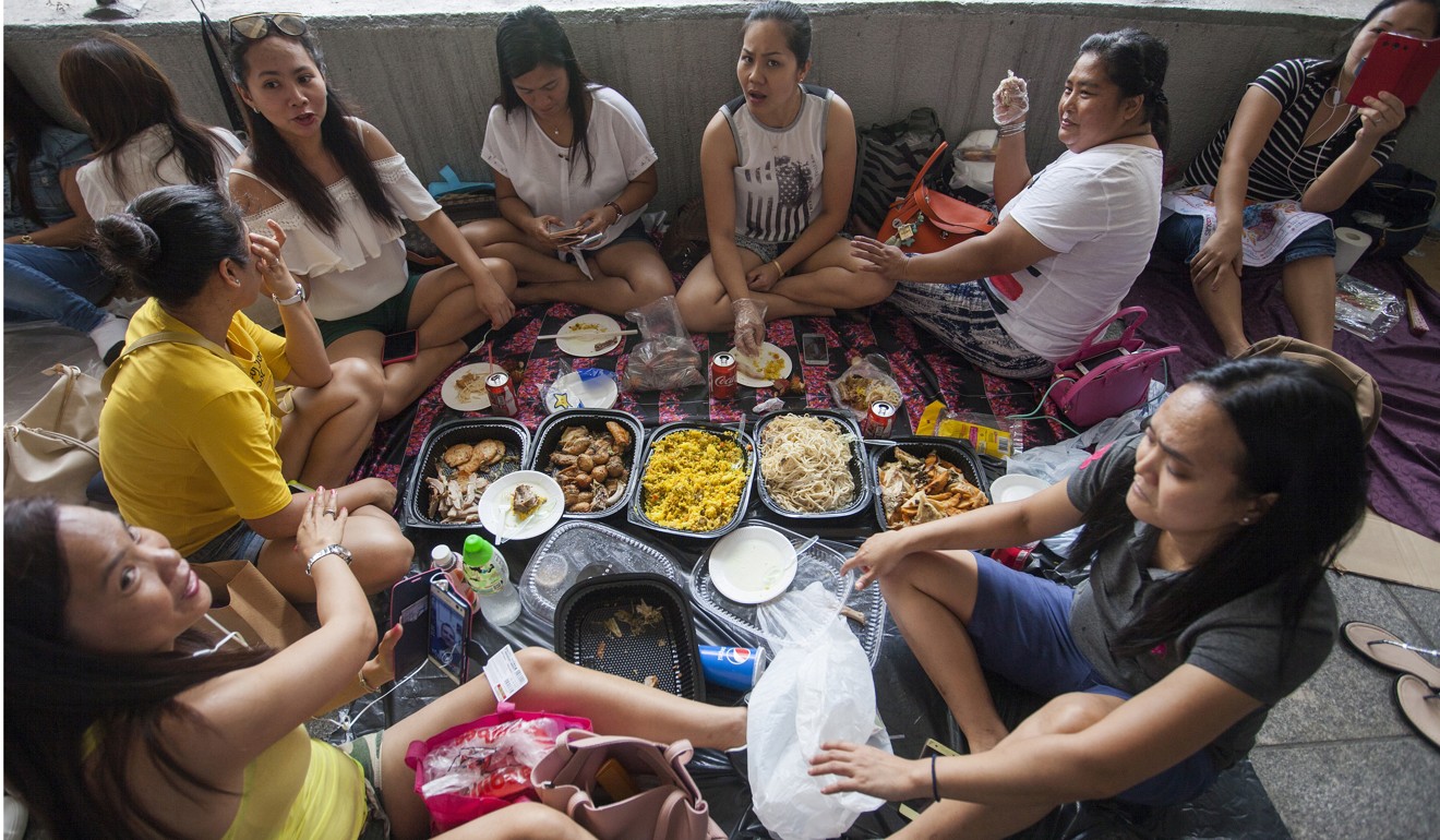 Domestic workers enjoy a picnic on their weekly day off, on May 27. Photo: EPA-EFE