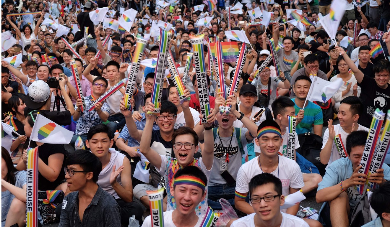 Gay rights activists celebrate a landmark decision by the constitutional court, paving the way for Taiwan to become the first place in Asia to legalise gay marriage, in Taipei on May 24, 2017. Photo: AFP