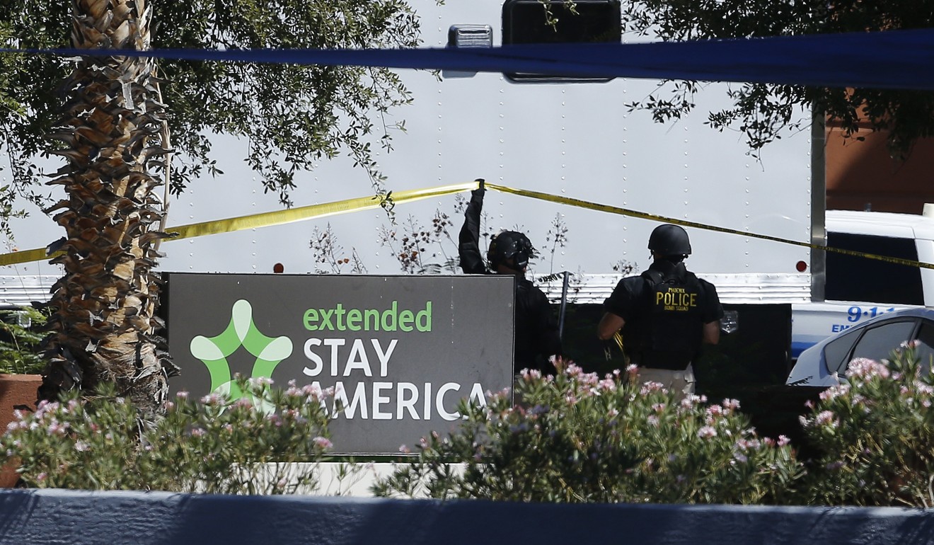 Police work at a hotel where a suspect wanted in several killings was staying on Monday in Scottsdale, Arizona. According to police, the suspect killed himself as police closed in on the hotel. Photo: AP