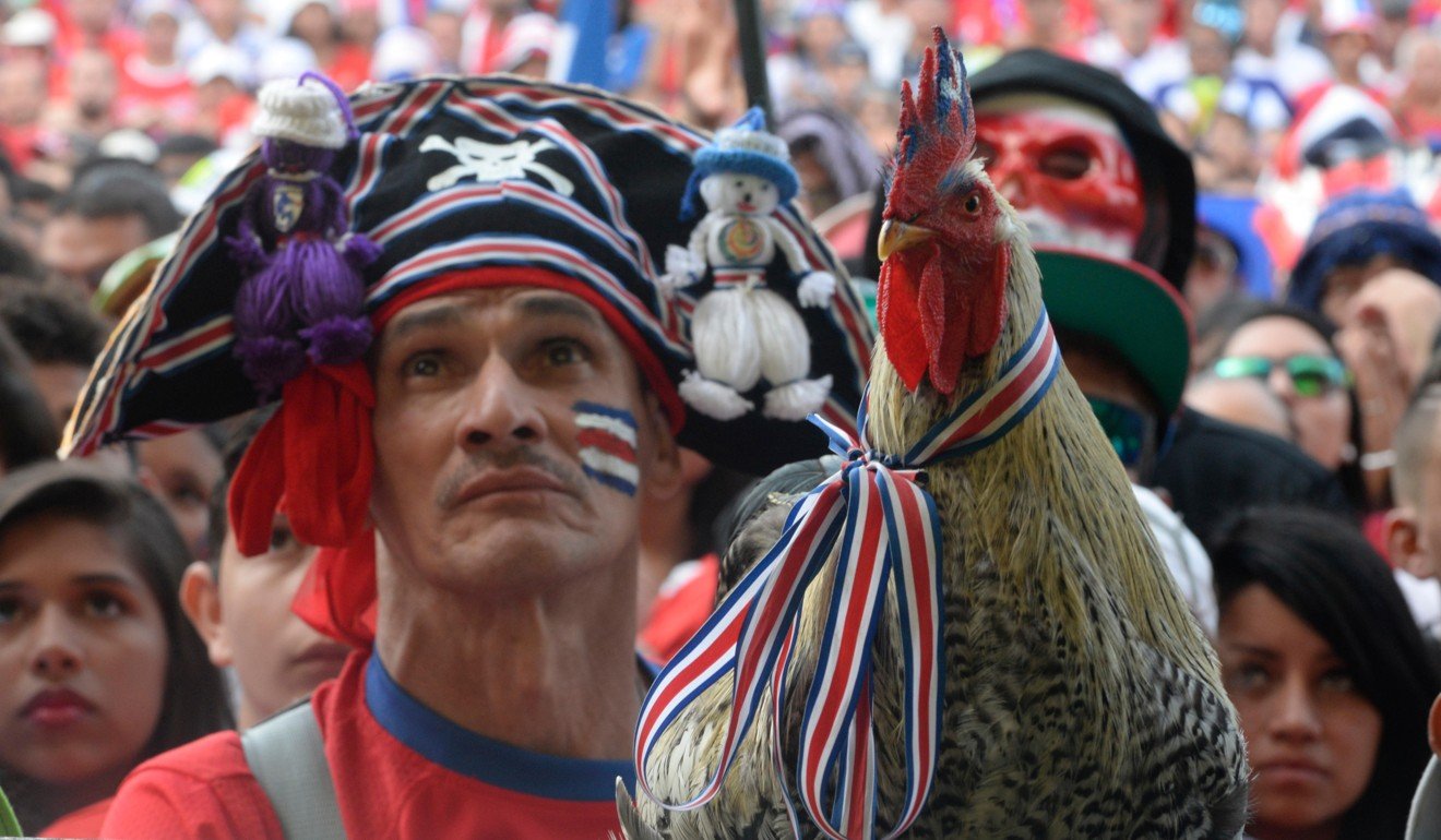 A Costa Rica fan complete with his pet rooster during the last World Cup. Picture: Alamy