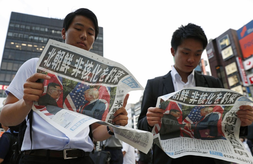 People in Tokyo read about the Trump-Kim summit in Japanese newspaper Mainichi Shimbun. Photo: AP