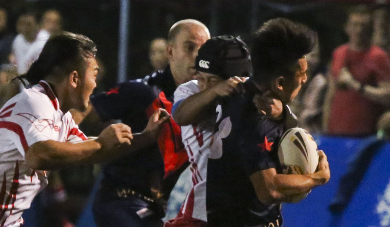 Ringo Lung (right) is tackled in Hong Kong’s first test match. Photo: Edmond So
