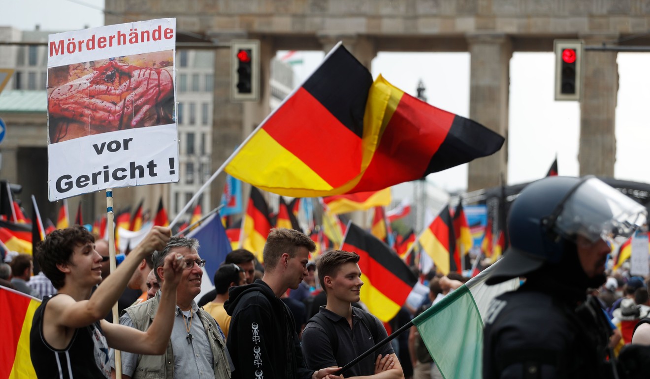 Right-wing AfD protesters wave German flags in front of the Brandenburg Gate in Berlin during the âdemonstration for the future of Germanyâ in Berlin on May 27. Photo: AFP