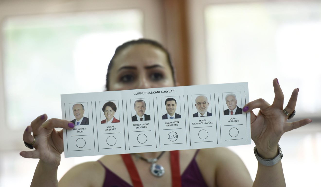 An election committee member shows a ballot. Photo: AFP