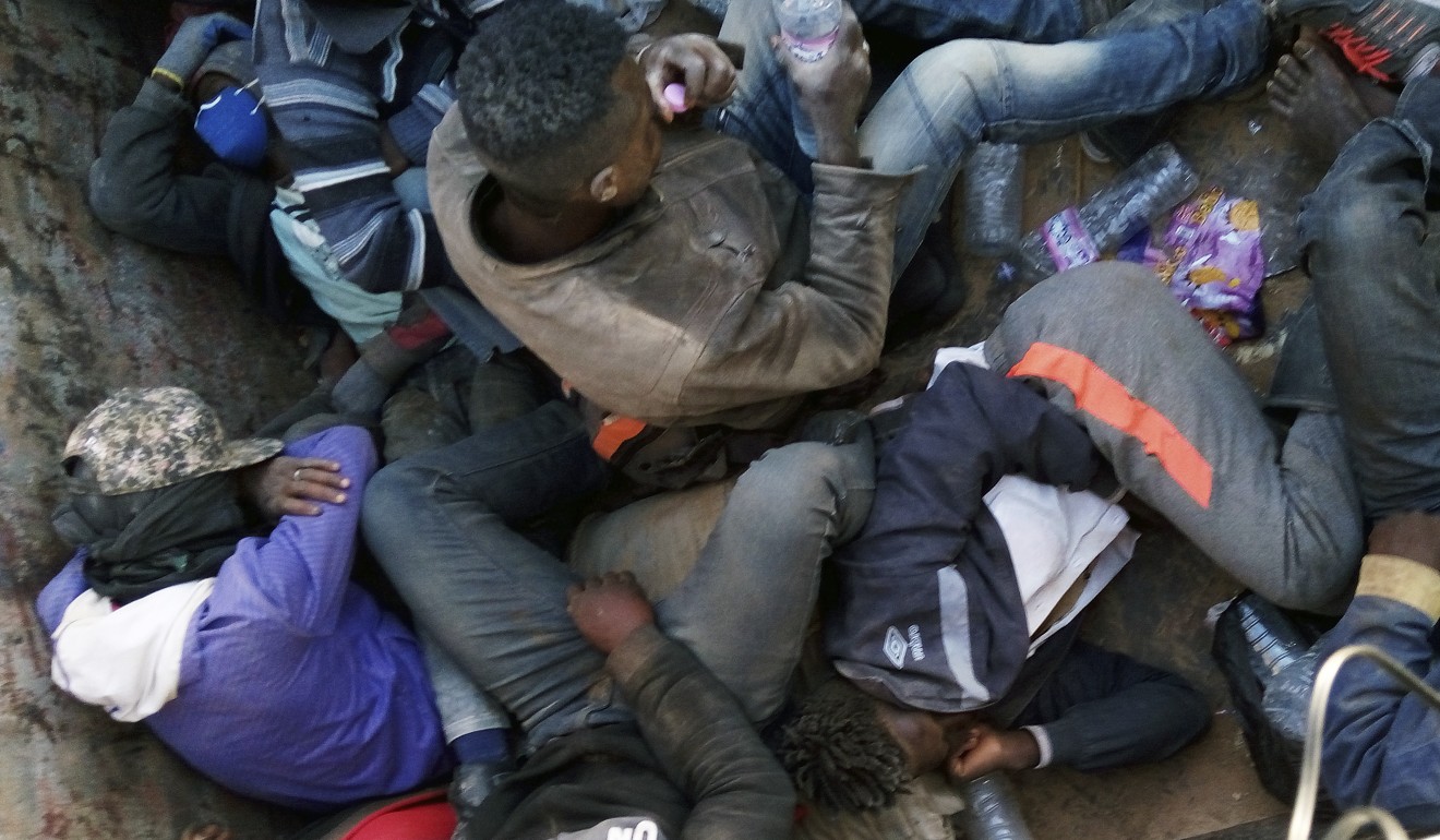 In this Wednesday, May 9, 2018 photo provided by Liberian Ju Dennis, fellow migrants being expelled from Algeria lie in a truck headed towards the Niger border at Point Zero, from which they must walk south into the Sahara Desert towards the Nigerien border post of Assamaka, 16km south. Photo: AP / Ju Dennis)