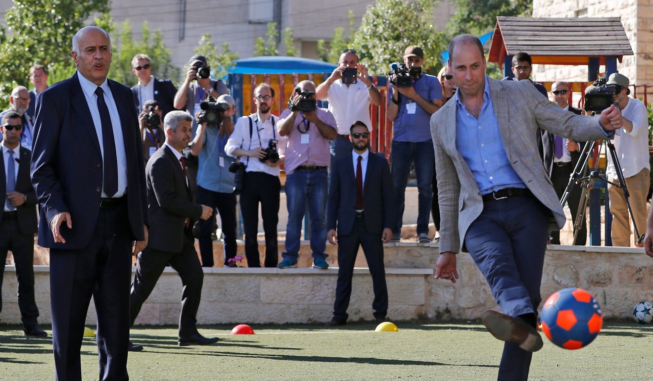 Prince William kicks a soccer ball next to the leader of the Palestinian Football Federation, Jibril Rajoub, in the West Bank city of Ramallah on Wednesday. Photo: AFP
