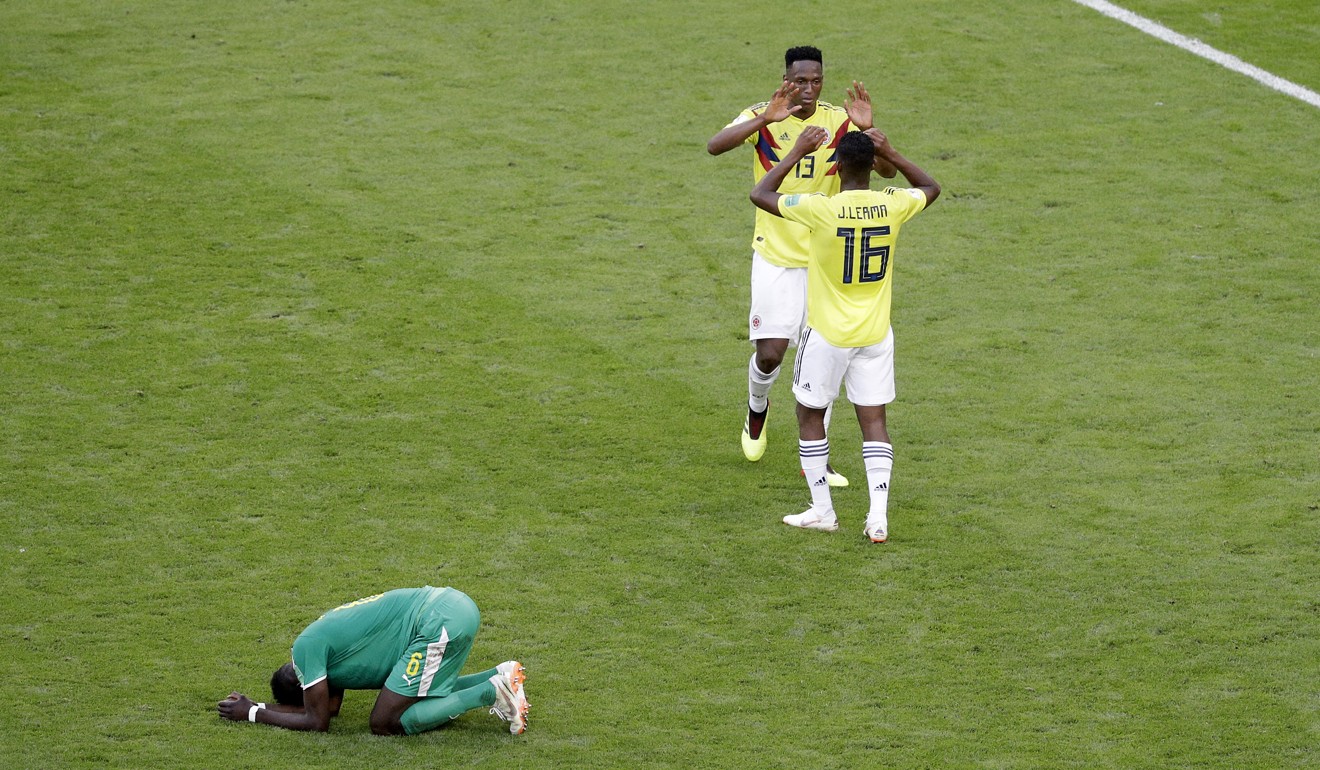 Colombia’s Yerry Mina and Jefferson Lerma celebrate after winning the group H match against Senegal as Senegal’s Salif Sane reacts. Photo: AP