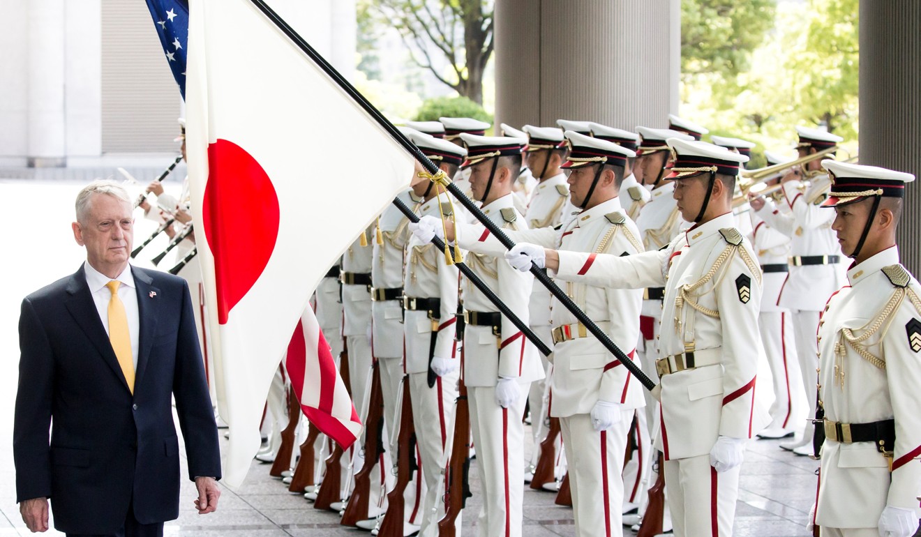 Mattis reviews an honor guard before his meeting with Onodera. Photo: Reuters