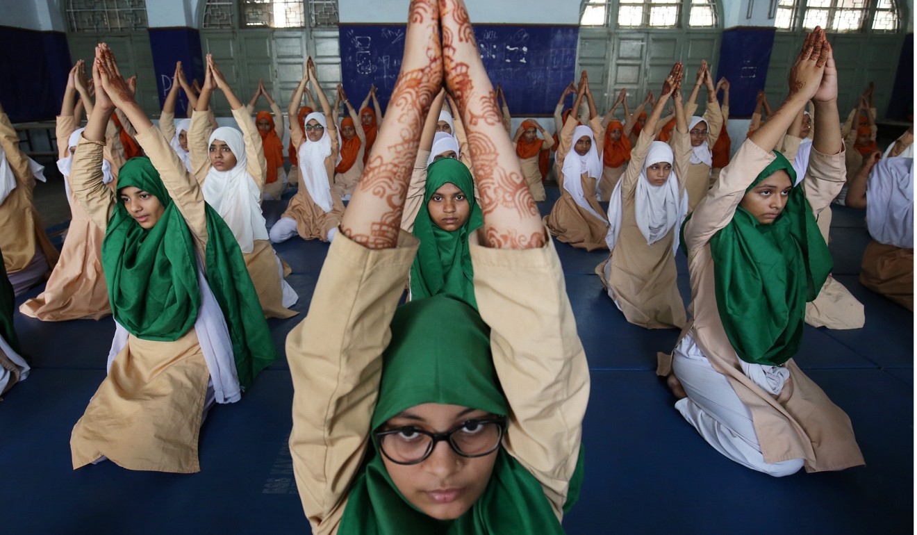 Muslim girls attend a yoga lesson at a school ahead of International Yoga Day in Ahmadabad, India. Photo: Reuters
