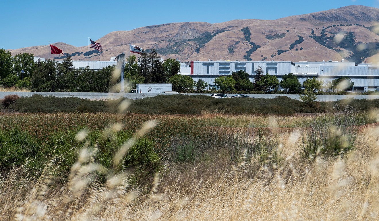 Flags fly outside the Tesla Inc. manufacturing facility in Fremont, California, on June 20. Photo: Bloomberg