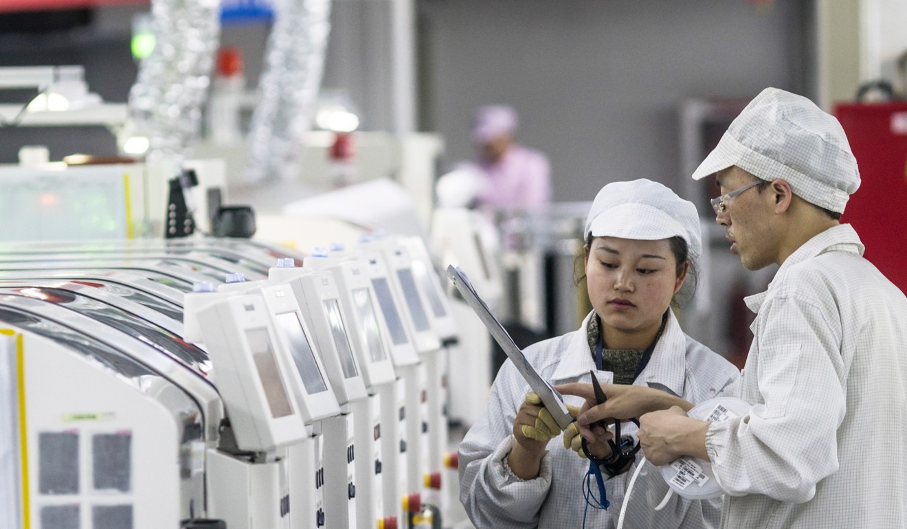 People work on machines at the Foxconn Technology Group factory in Guiyang, Guizhou province, in May. The factory produced 16 million smartphones for Nokia and Huawei in 2017 and hopes to reach 30 million in 2018. Photo: EPA-EFE