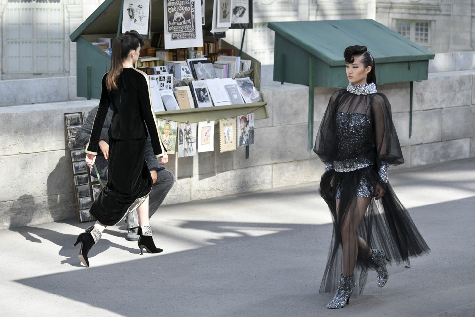 Lagerfeld opts for a refined sobriety of sharply-cut black and grey slit dresses, worn over short thigh-riding miniskirts. Photo: Xinhua/Piero Biasion