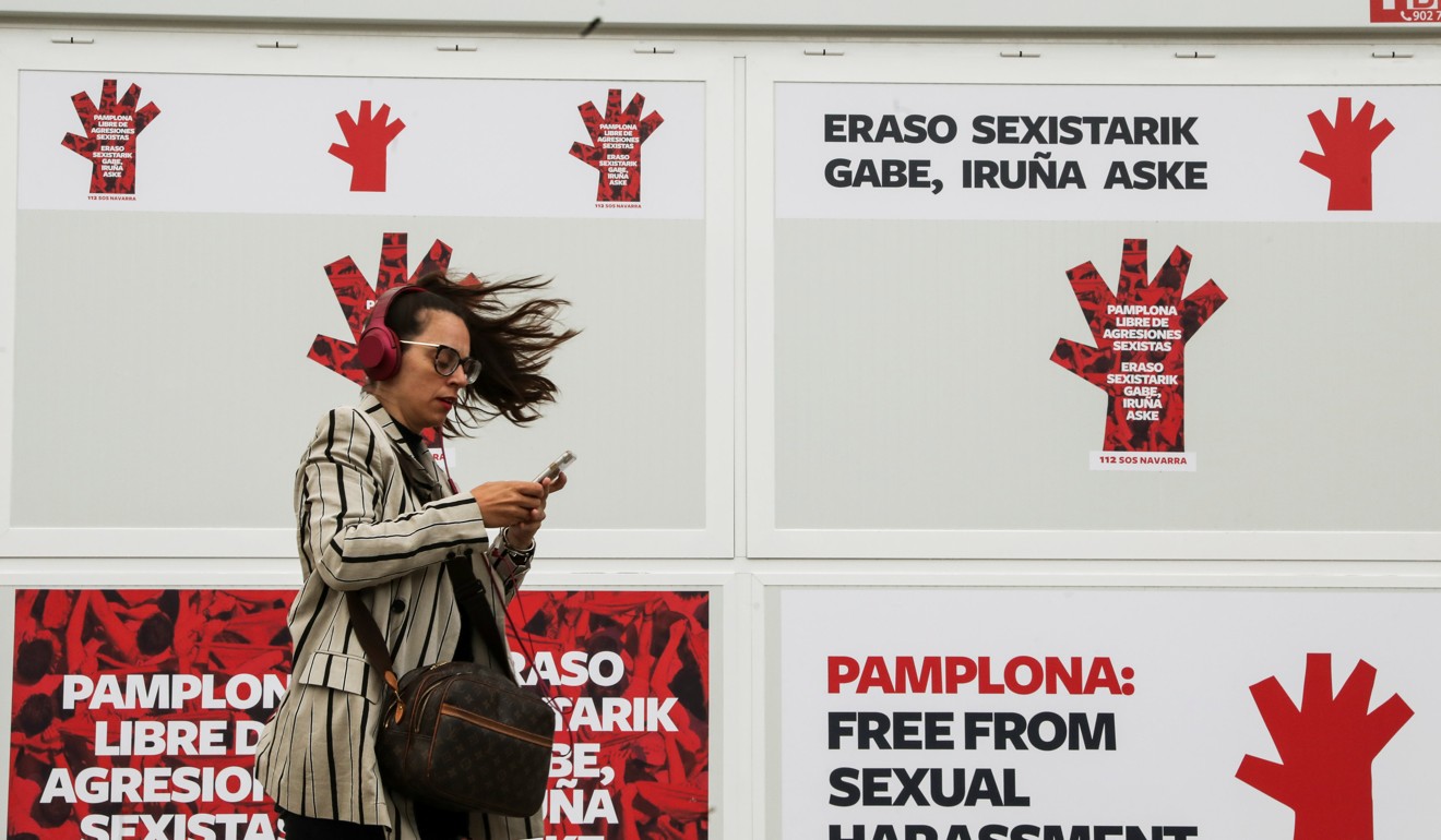 A woman walks past an information and helpline booth on sexual violence two days before the annual San Fermin bull-running festival in Pamplona. Photo: Reuters