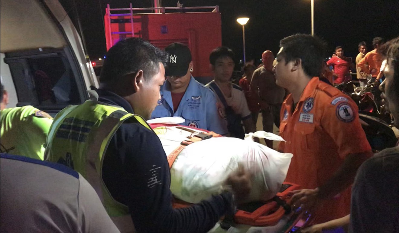 Thai rescue personnel carry a body bag bearing the recovered body of a passenger from the capsized tourist boat the Phoenix on Thursday night. Photo: Agence France-Presse