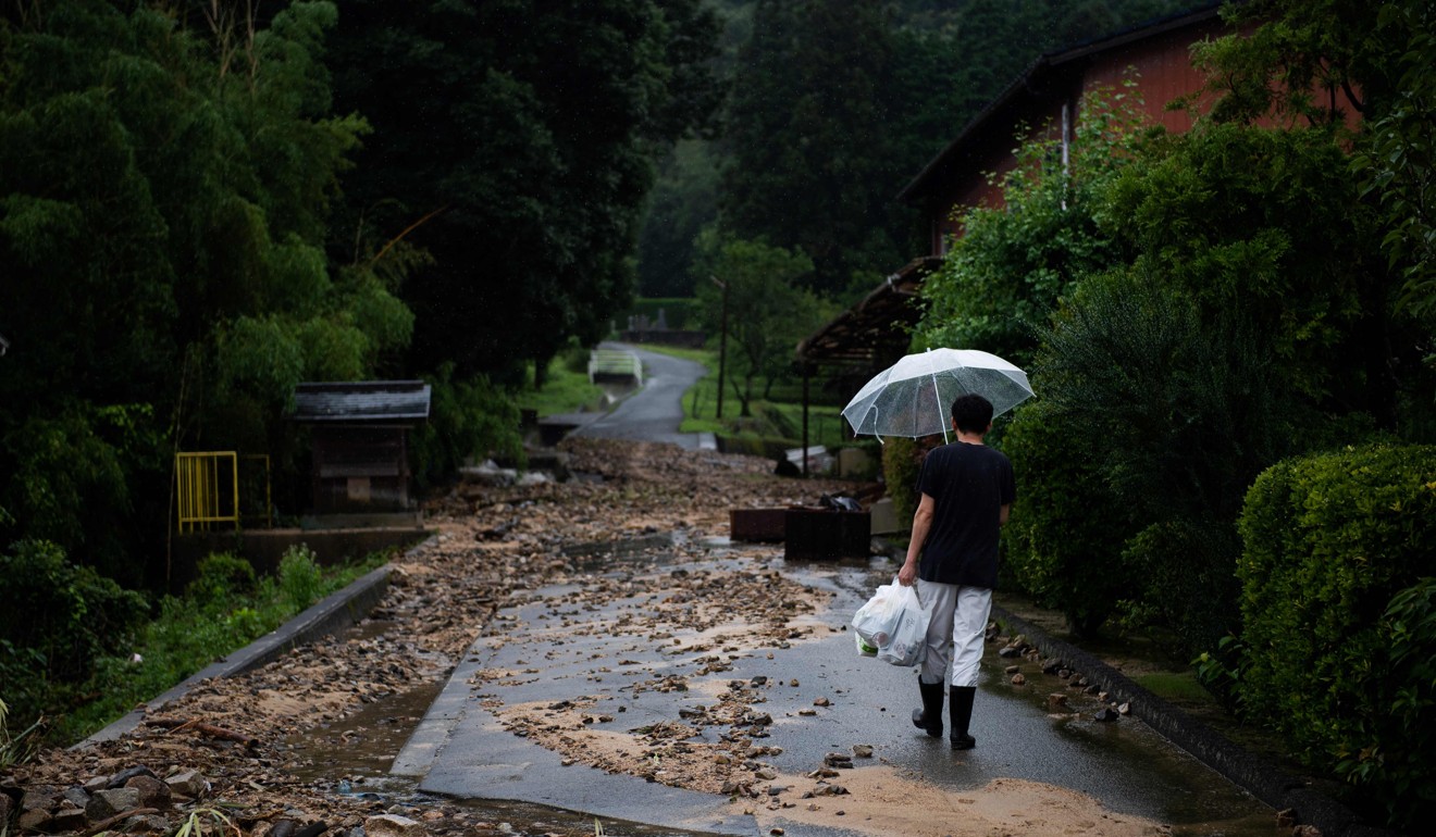 A road in Mihara on Sunday. Japan’s Prime Minister Shinzo Abe warned of a “race against time” to rescue flood victims. Photo: AFP