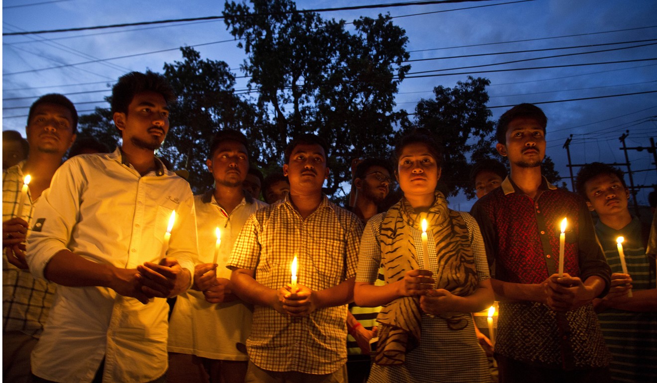 Supporters of Nilotpal Das and Abhijit Nath, who were killed by mobs, hold candles during a protest in Gauhati, India. Photo: AP