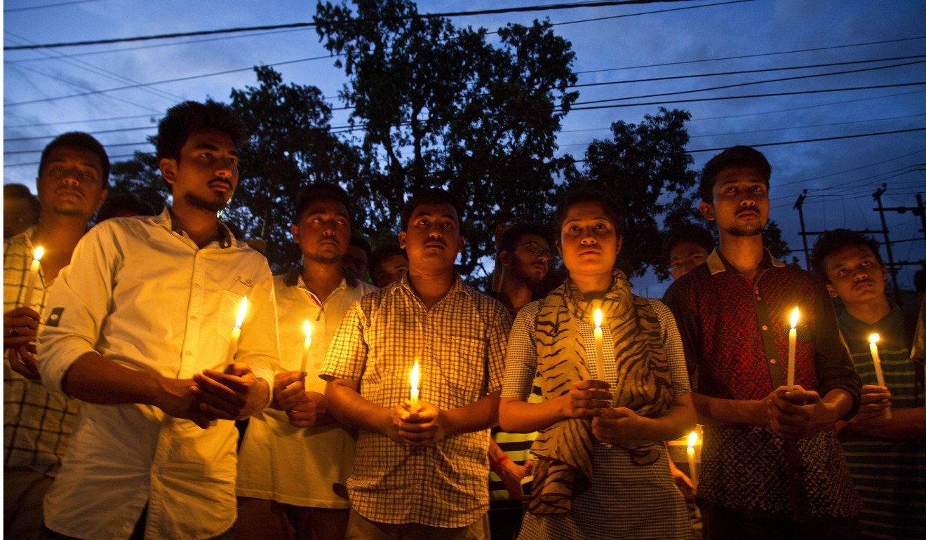 Supporters of Nilotpal Das and Abhijit Nath, who were killed by mobs, hold candles during a protest in Gauhati, India. Photo: AP