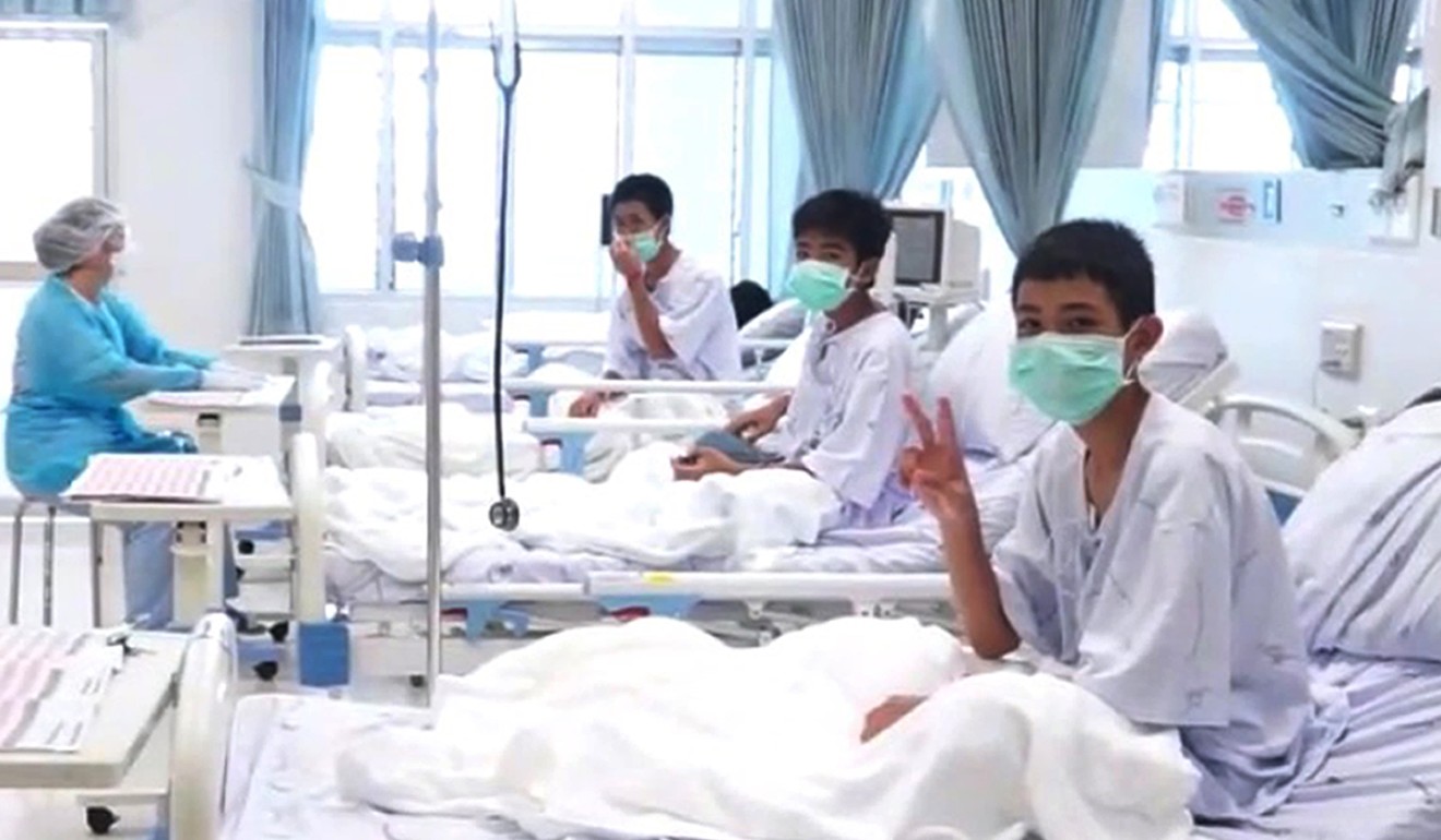 The first picture of the boys being treated in hospital after their rescue. Photo: EPA