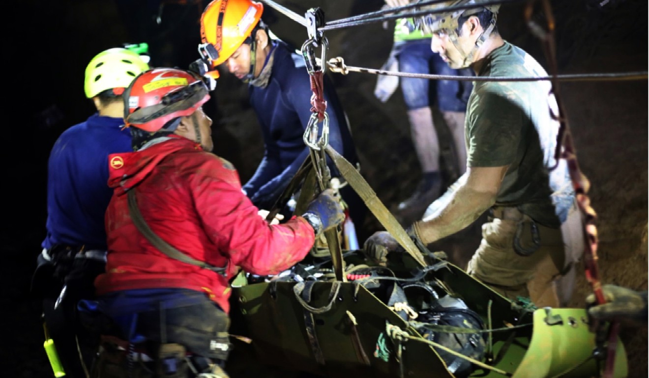 Rescuers carry one of the soccer team members. Photo: EPA