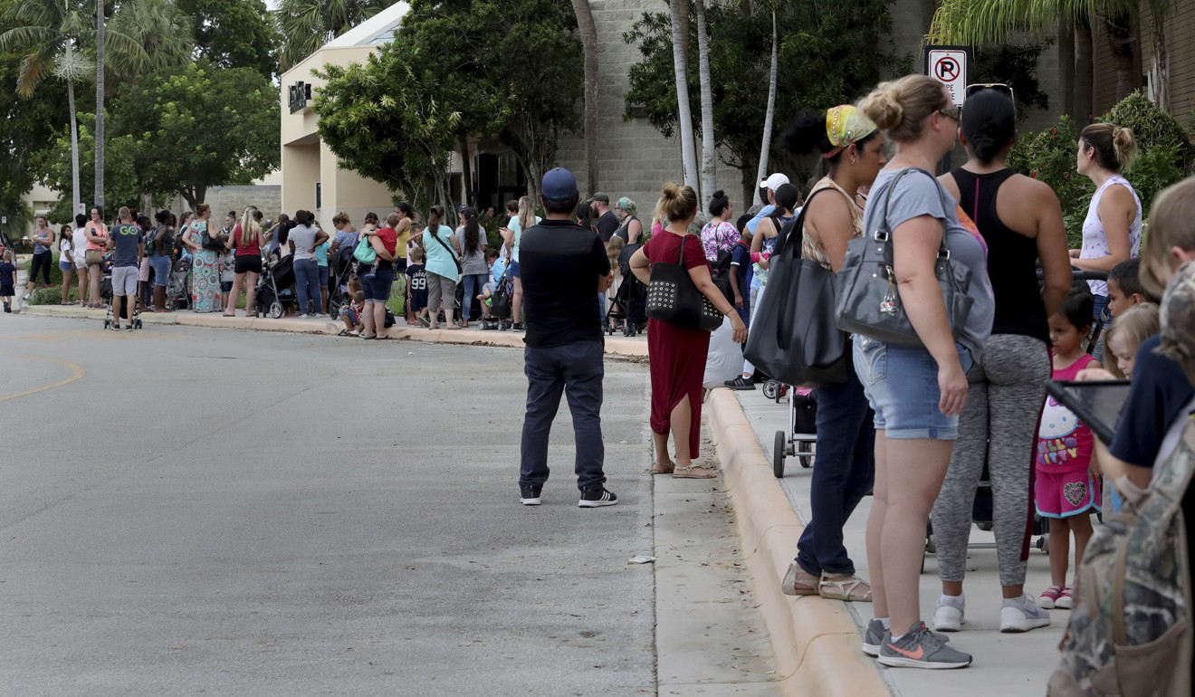 Parents and kids wait in line f in Coral Springs, Florida, for the Build-A-Bear Workshop Pay Your Age event on Thursday. Photo: AP