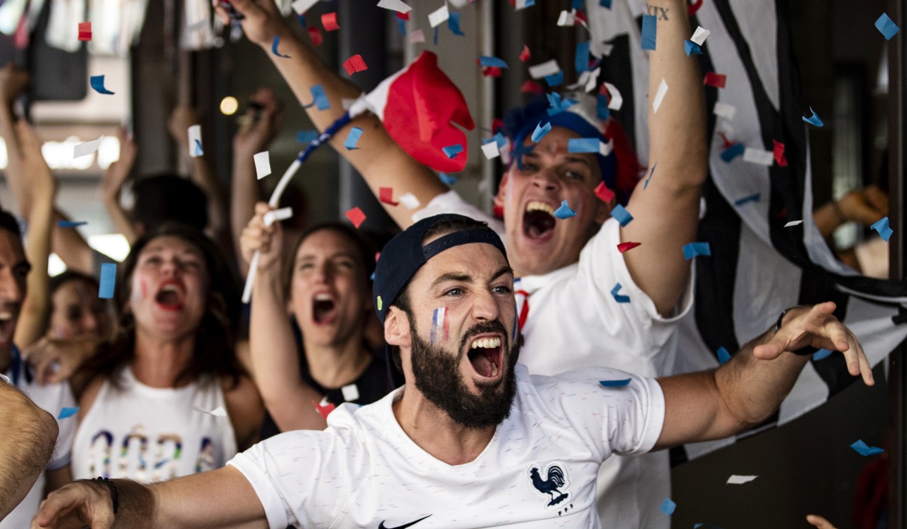 French supporters react in a bar after France scored for the fourth time during the final. Photo: EPA