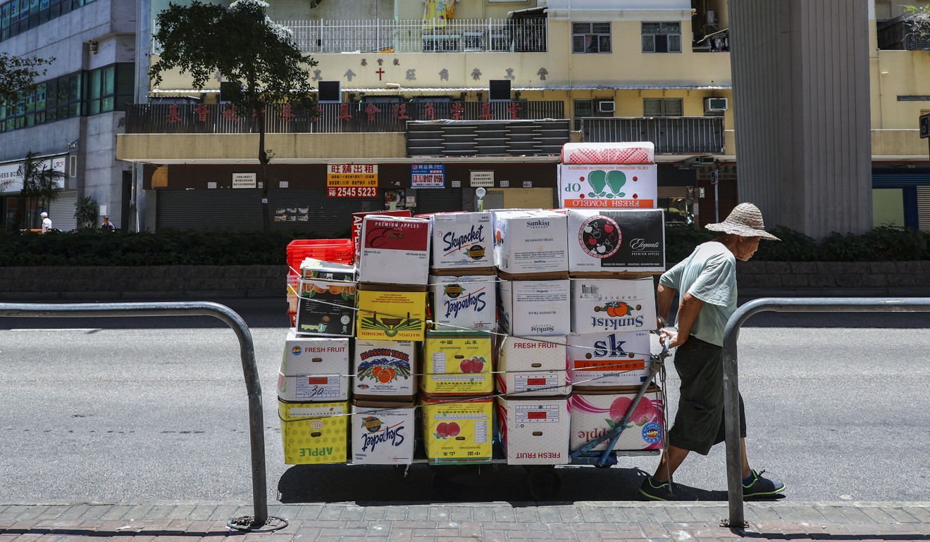 An elderly man collects cardboard in Mong Kok to earn money. It’s resilience such as this that stand the Hong Kong people in good stead, Goodstadt believes. Photo: Sam Tsang