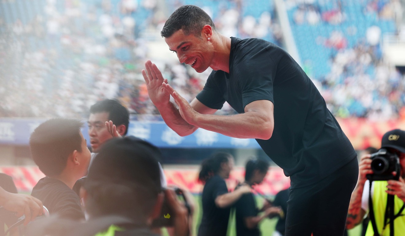 Ronaldo greets young players at a promotional event in Beijing, China. Photo: Xinhua