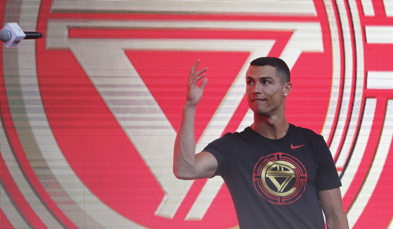 Ronaldo throws a microphone during his visit to Beijing. Ronaldo is in China for his annual 'CR7 tour'. Photo: EPA