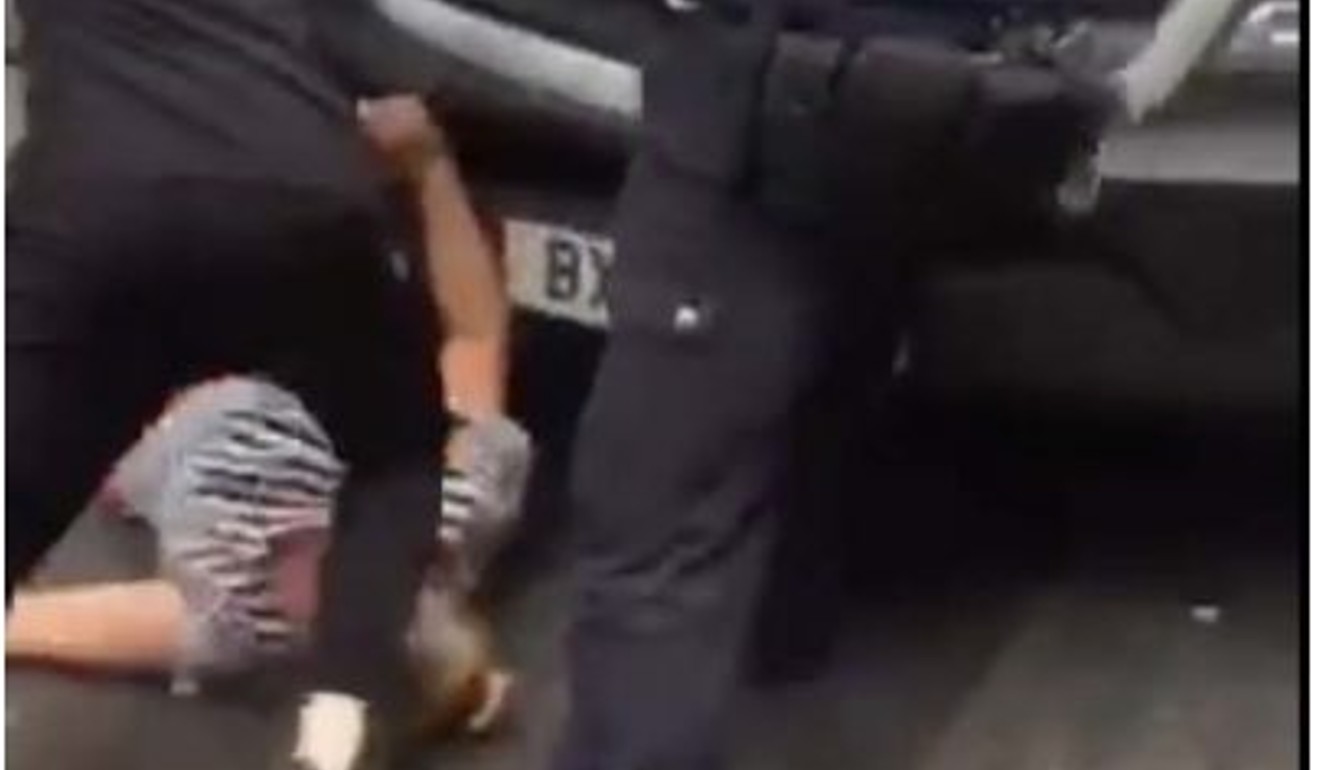 An immigration van appears to strike a woman on Gerrard Street in London's Chinatown, as police push the vehicle back, during July 5 raids. Photos: YouTube