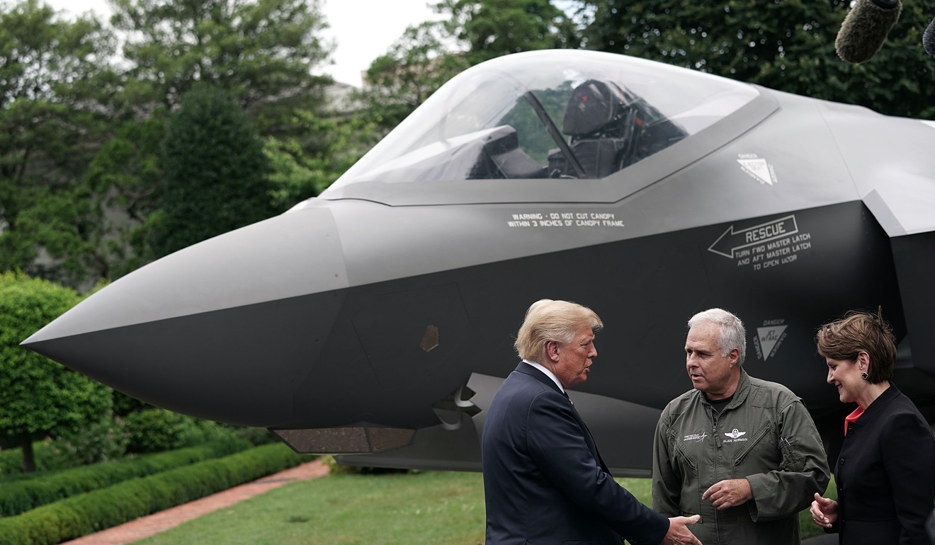 US President Donald Trump, left, speaks to Marillyn Hewson, president and chief executive officer of Lockheed Martin Corp., right, and chief test pilot Alan Norman next to a Lockheed Martin F-35 fighter jet during a “Made in America Products Showcase” at the White House on Monday. Photo: Bloomberg