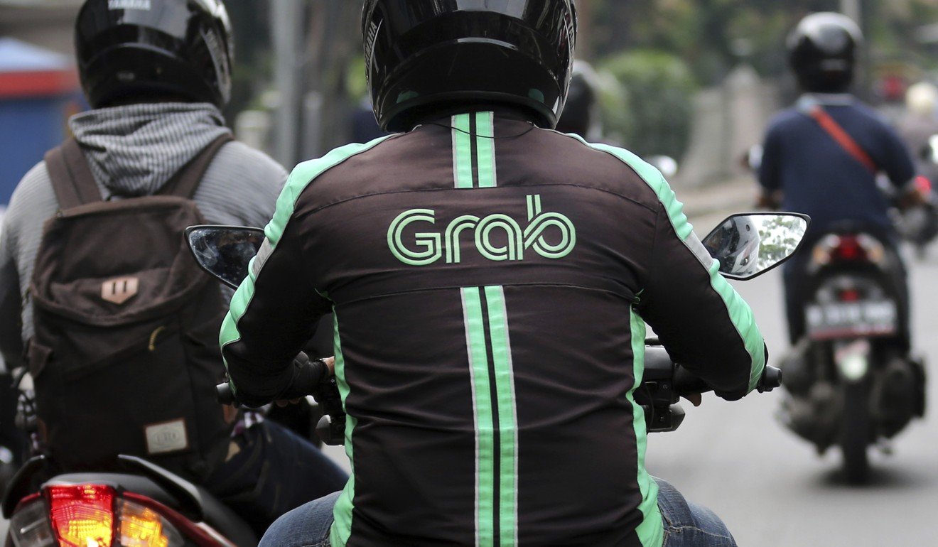 A GrabBike driver rides his motorbike in Jakarta, Indonesia, in July 2017. The ride-hailing firm dominates the Southeast Asian market. Photo: AP